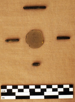 Figure 1.  Ground glass lens and slate pencil fragments recovered during excavations of the Banneker homestead.  Photograph courtesy of Maryland Archaeological Conservation Laboratory.